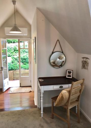 a room with a desk and a mirror on the wall at Mountain Studio Escape in Mount Tamborine