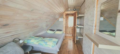 a small room with two beds in a tiny house at Partsilombi Holiday Home in Otepää