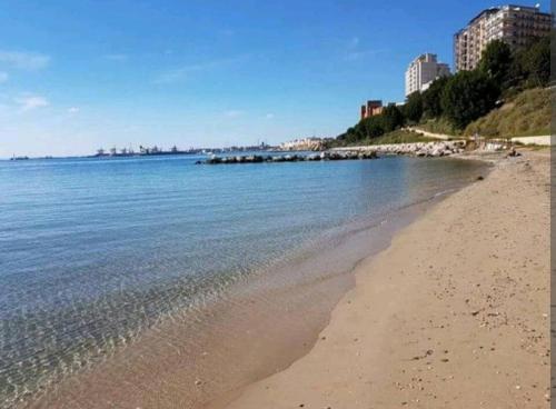 a beach with the ocean and buildings in the background at Casa Principe Taranto "Intero appartamento" in Taranto
