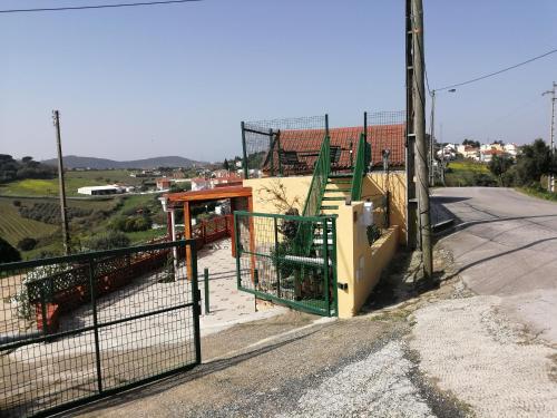 a building with a gate on the side of a road at Varandas da Serra II in Vila Franca de Xira