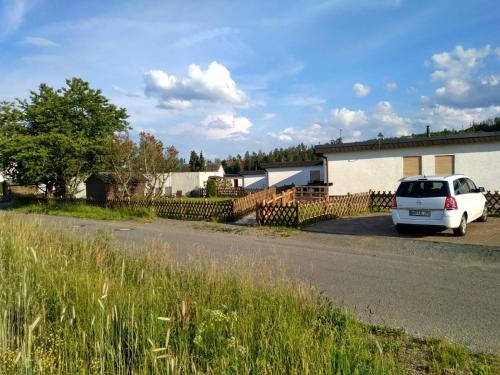 a white car parked on the side of a road at Haus Panoramablick in Medebach