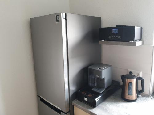 a stainless steel refrigerator in a kitchen with a coffee maker at Ferienwohnung Müller in Kenzingen