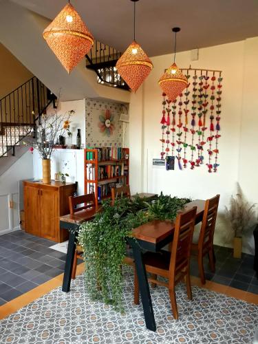 a dining room with a table and chairs at Pink Tulip Hoi An in Hoi An