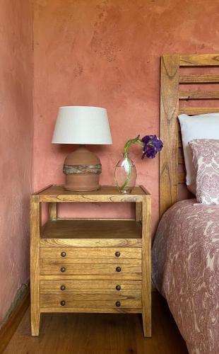a nightstand with a lamp on it next to a bed at Son de Mar Hotel rural & Apartamento in Quintueles