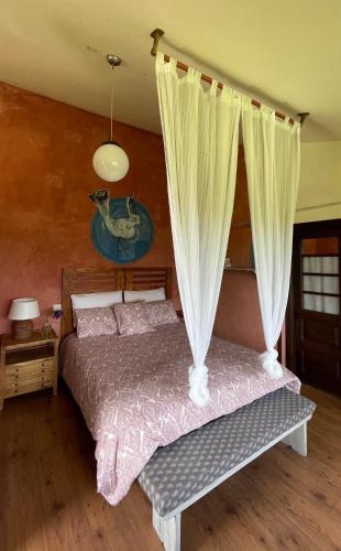 a bedroom with a bed with a canopy at Son de Mar Hotel rural & Apartamento in Quintueles