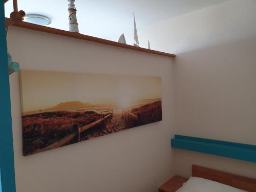 a picture on a wall with a painting on it at Kleine Hafenliebe in Fehmarn