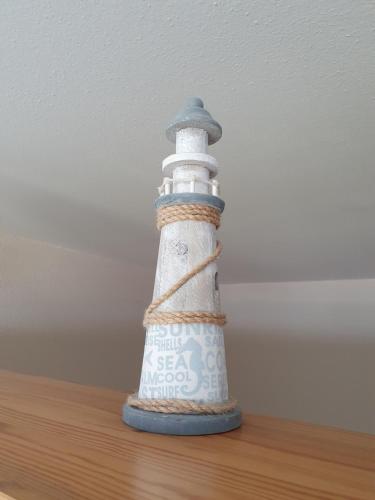 a lighthouse figurine sitting on top of a table at Kleine Hafenliebe in Fehmarn