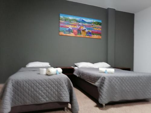 two beds sitting next to each other in a room at Suite Trujillo in Trujillo