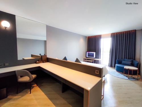 a hospital room with a long desk and chairs at Golden City Rayong Hotel in Rayong