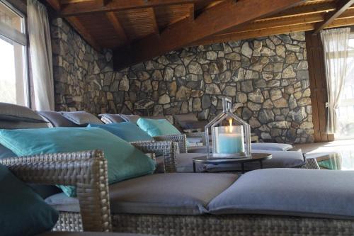 a room with chairs and a stone wall with a candle at Hotel Hennemann in Cobbenrode