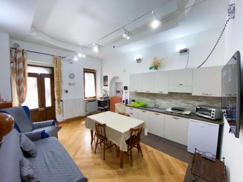 a kitchen and a living room with a table at B&B Barone in Rionero in Vulture