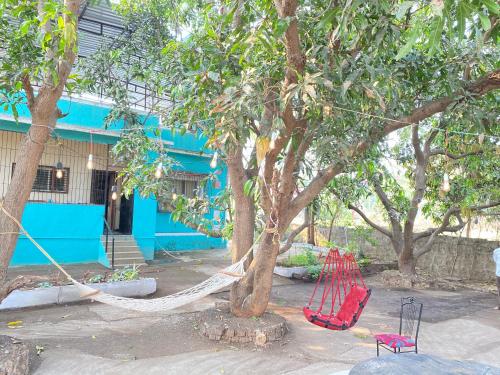 a hammock tied to a tree in front of a building at Sukh Villas - Best Budget villa in Karjat in Karjat