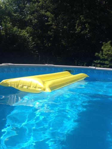 un toboggan jaune dans la piscine dans l'établissement Le Jolie Grenier a Foin, à Saulgond