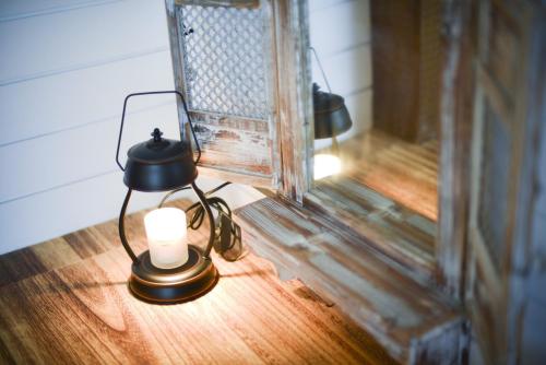 a lamp sitting on a table with a candle at 白鹿詩行旅 in Tainan