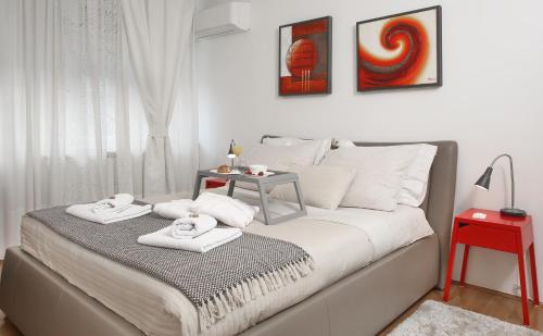 a bedroom with a bed with towels on it at Happy Guest Apartment Zagreb in Zagreb