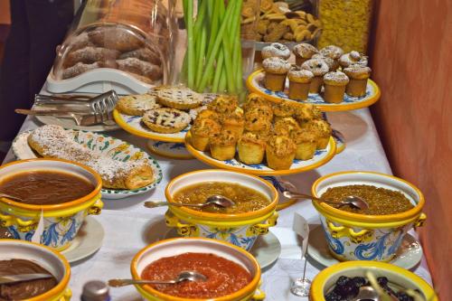 a table filled with different types of food and desserts at Agriturismo Vecchia Masseria Charme&Relax in San Michele di Ganzaria