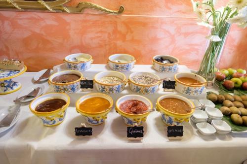 a table topped with bowls of different types of food at Agriturismo Vecchia Masseria Charme&Relax in San Michele di Ganzaria