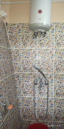 a shower in a bathroom with a tiled wall at Poomong Homestay in Darjeeling
