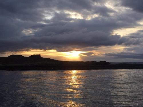a sunset over a large body of water at Borgir - The House by the Sea in Borgir