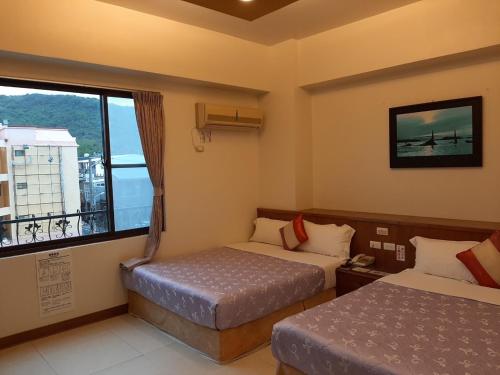 Cama o camas de una habitación en Nanwan Jiahewu Inn