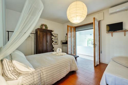 a bedroom with a large bed and a television at Ca' dei Noccioli in Mirano