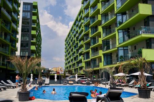 a swimming pool in front of two tall buildings at Sea Shore apartments - Spa n Pools beach resort in Mamaia