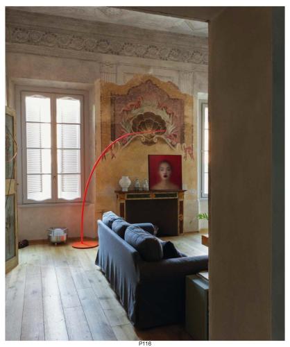 a living room with a couch and a red hose at Appartamento affrescato 180mq in palazzo del 600 a Mantova in Mantova