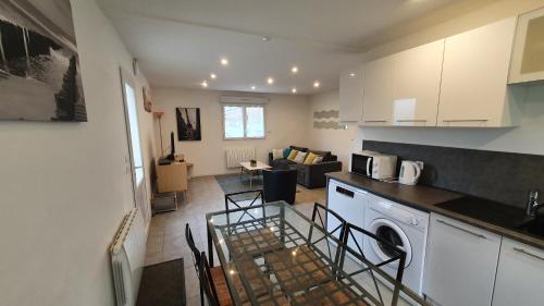 a kitchen and a living room with a counter top at pepiniere in Nogent-sur-Seine