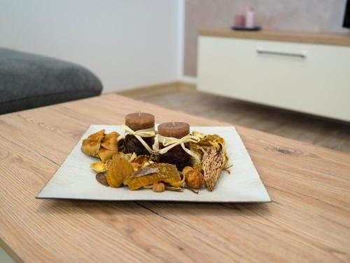a plate of food sitting on top of a table at Armony Apartament Timisoara in Timişoara