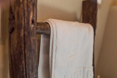 a towel is hanging on a wooden door at Piazza San Donato Casa Vacanze in Bagnoregio