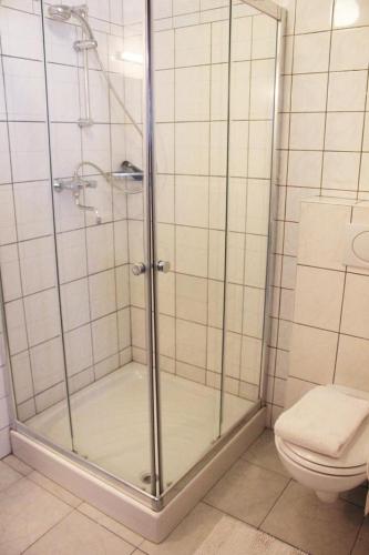 a shower stall in a bathroom with a toilet at Hotel Cafe 't Zonneke in Oosterhout