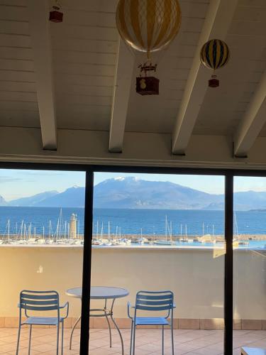 a view of the ocean from a room with a table and chairs at Molino Apartments in Desenzano del Garda
