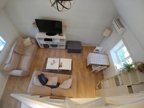 an overhead view of a living room with a couch and a tv at Rosdala gård - gästhuset in Rydsgård