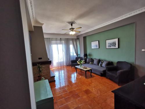 a living room with a couch and a table at Aegean Blu Port House Pythagoreio in Pythagoreio