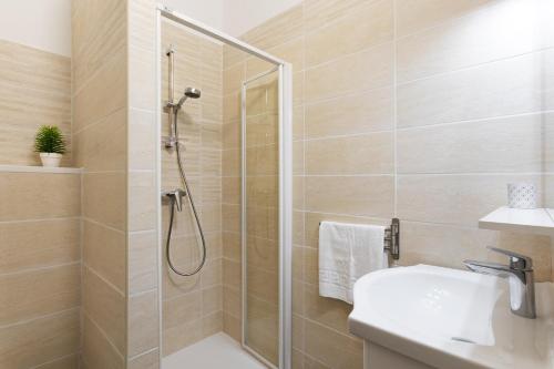 a bathroom with a shower and a sink at Residence Helios in Cargèse