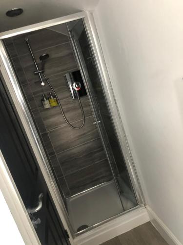 a shower in a bathroom with a glass window at City Centre Victorian Terrace in Cardiff