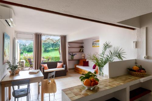 a living room with a couch and a table at Residence Helios in Cargèse