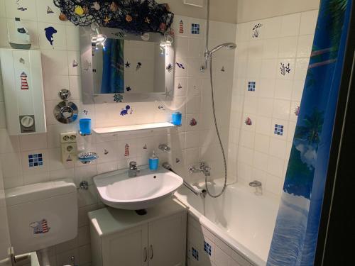 a bathroom with a sink and a shower at Südstrandwohnung in Fehmarn