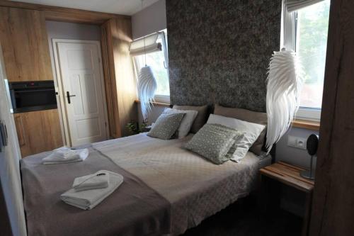 sypialnia z łóżkiem z dwoma ręcznikami w obiekcie APARTAMENT Inspiracja w mieście Mrągowo