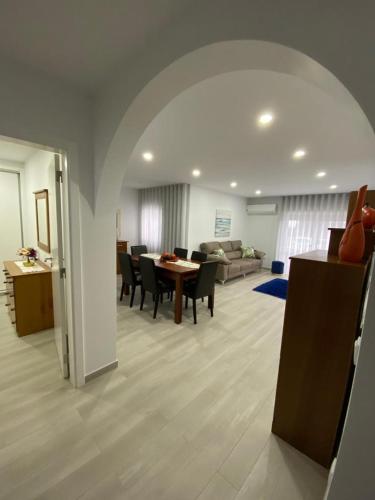 a large living room with a table and chairs at Gina House in Nazaré