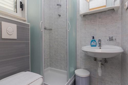 a bathroom with a shower and a sink at Apartments Erceg in Makarska
