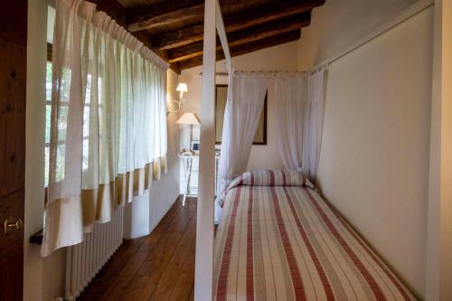 a bedroom with a bed in a room with a window at Agriturismo La Vigna di Sarah in Vittorio Veneto