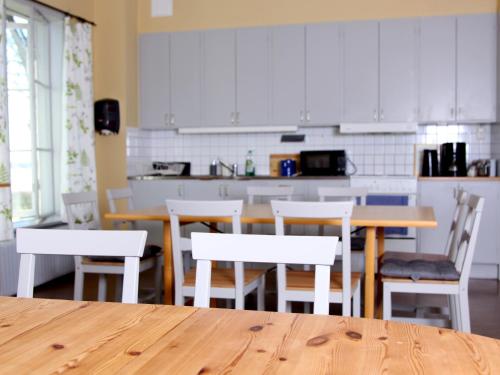 a kitchen with a wooden table and chairs and a counter at Gripsholms BnB in Mariefred