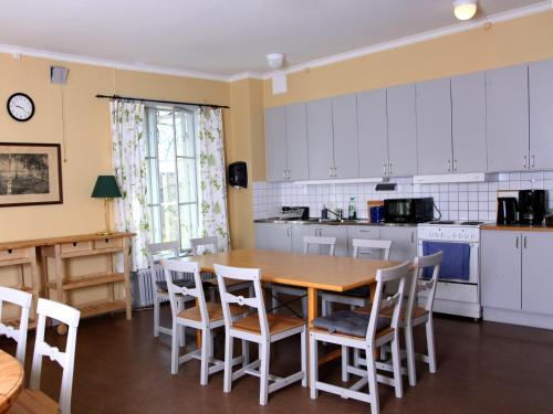 a kitchen with a wooden table and chairs at Gripsholms BnB in Mariefred
