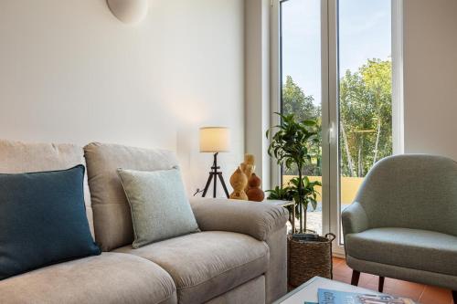 a living room with a couch and a chair at QSF Agro Turismo Quinta da Sagrada Família in Évora