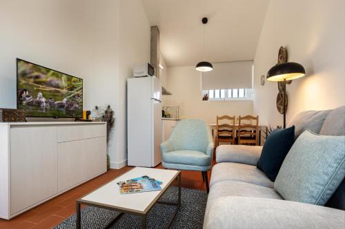 a living room with a couch and a refrigerator at QSF Agro Turismo Quinta da Sagrada Família in Évora