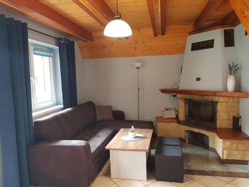 a living room with a couch and a fireplace at CIME Ekonomik in Brenna