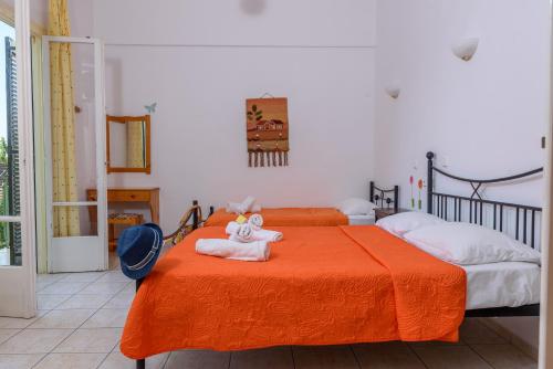a bedroom with two beds with towels on it at Des Roses Hotel in Platanias