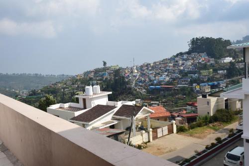 a view of a city from the roof of a building at B2B Home Stay in Kodaikānāl