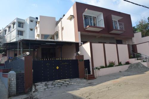a house with a gate in front of it at B2B Home Stay in Kodaikānāl